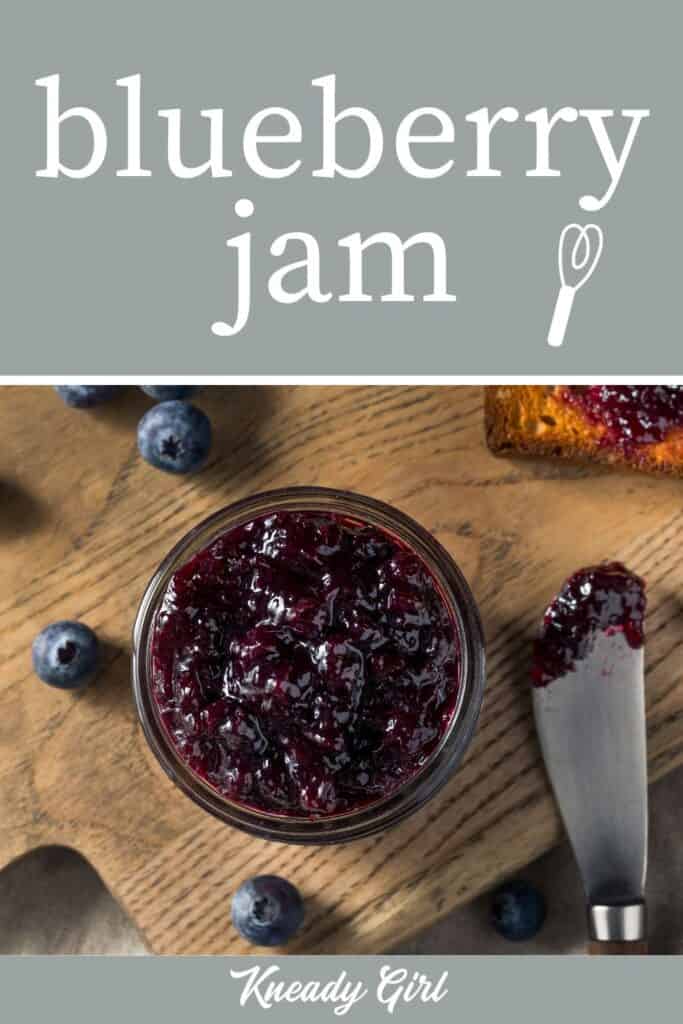 An open jar of blueberry jam seen from above with a spreader and piece of toast with a text overlay.