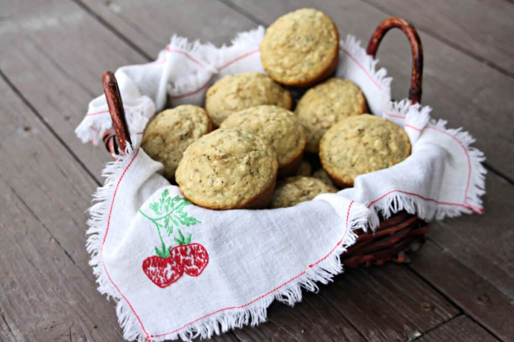 A napkin lined basket full of hemp heart and oatmeal muffins 