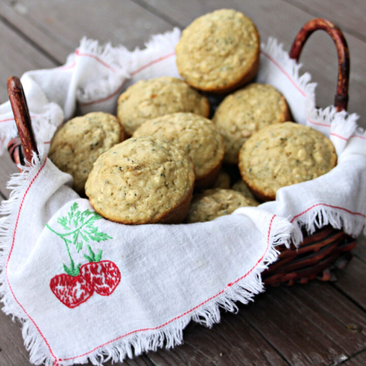 Hemp heart muffins stacked in a napkin lined basket.