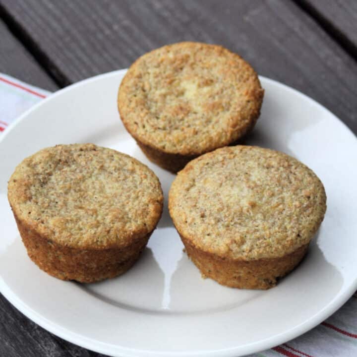 3 yogurt bran muffins sitting on a white plate.