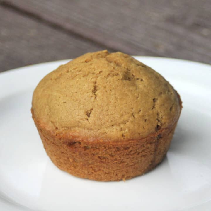 A coffee muffin on a white plate.