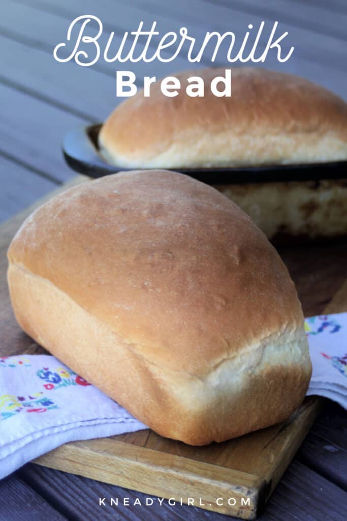 2 loaves of buttermilk bread on a cutting board with a floral napkin and text overlay.