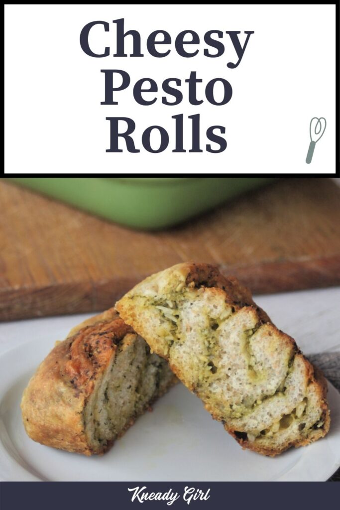 A cheesy pesto roll sliced in half on a white plate with text overlay.