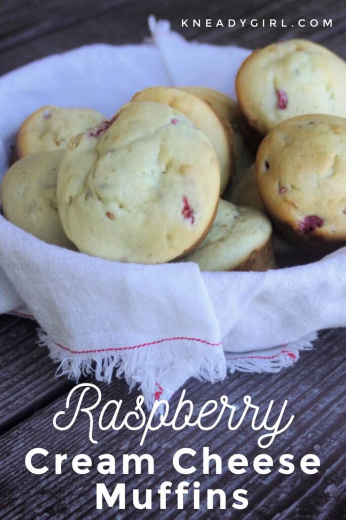 A white linen basket full of raspberry cream cheese muffins with text overlay.