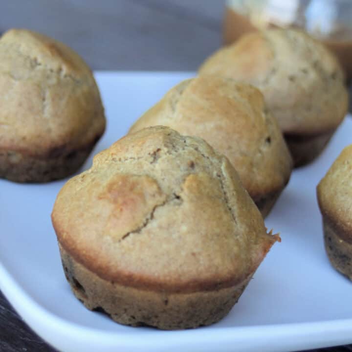 Close up of apple butter muffins on a white plate.