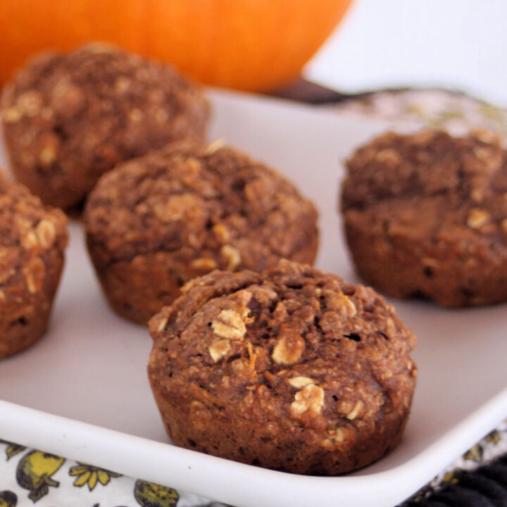 Healthy pumpkin muffins on a square white plate.