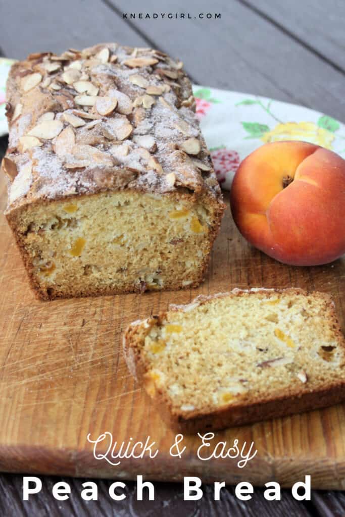 A loaf of peach bread on a wooden cutting board sitting behind a slice of bread with a fresh peach to the right side with text overlay.