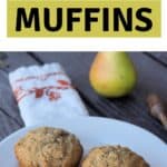 2 muffins on a white plate with a napkin, fresh pear, and honey dipper in the background with text overlay reading: ginger vanilla pear muffins.
