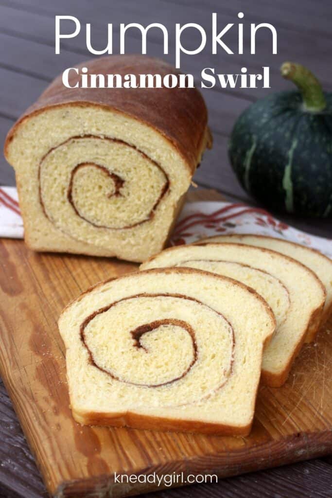 Slices of bread on a board sitting in front of the remaining loaf with a green pumpkin in the background and text overlay reading: pumpkin cinnamon swirl.