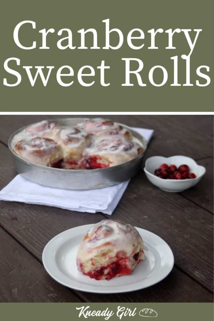 A cranberry sweet roll sitting on a white plate with a napkin sitting underneath a pan full of rolls and a white dish full of fresh cranberries in the background with text overlay reading cranberry sweet rolls. 