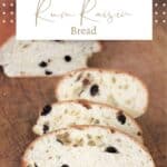 Slices of rum raisin bread sitting on a cutting board with rest of loaf sitting in the background with text overlay stating: Rum Raisin Bread.
