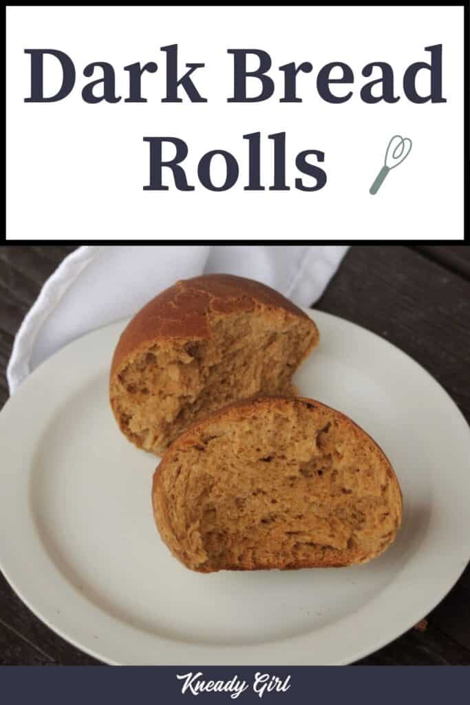 A brown bread roll cut in half on a white plate with a white napkin and text overlay reading dark bread rolls.