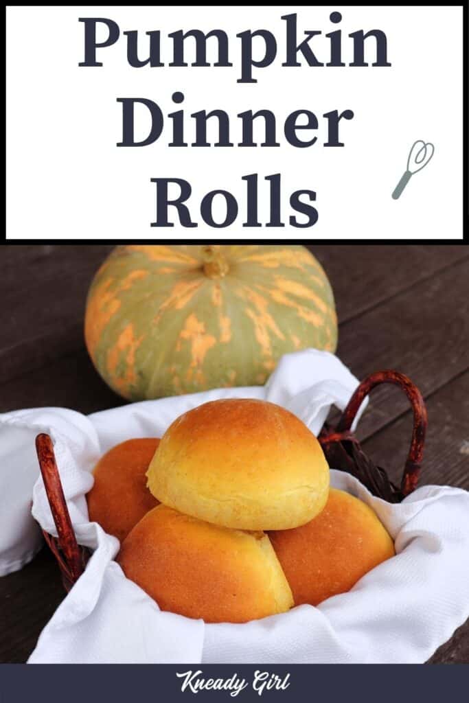 A white napkin lined basket full of pumpkin dinner rolls sitting in front of a green and orange striped pumpkin with text overlay stating: Pumpkin Dinner Rolls..