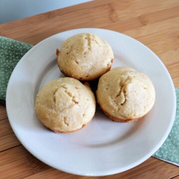 3 butter rum muffins as seen from above sitting on a white plate.