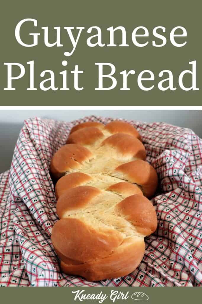 A braided loaf of bread sitting on a checked piece of cloth with text overlay stating: Guyanese Plait Bread.