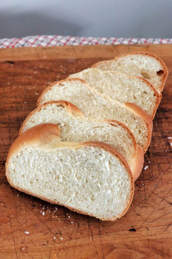 Slices of guyanese bread on a wooden cutting board.