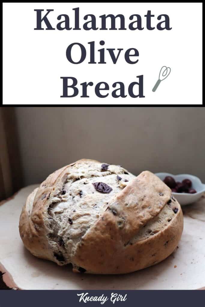 A loaf of bread sitting on a board with a bowl of olives in the background. A text overlay reads: kalamata olive bread. 
