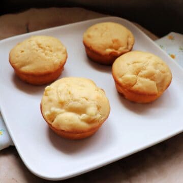 4 pineapple muffins on a square white plate.