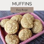 Muffins stacked in a basket lined with a red and white checkered cloth. Text overlay reads: applesauce bran muffins easy recipe.
