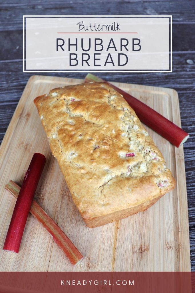 A loaf of quick bread on a board surrounded by red stalks of rhubarb. Text overlay reads: Buttermilk Rhubarb Bread. 