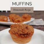 A cinnamon muffin on a white plate with a platter of more muffins in the background. Text overlay reads: Easy Cinnamon Muffins - Homemade Recipe.