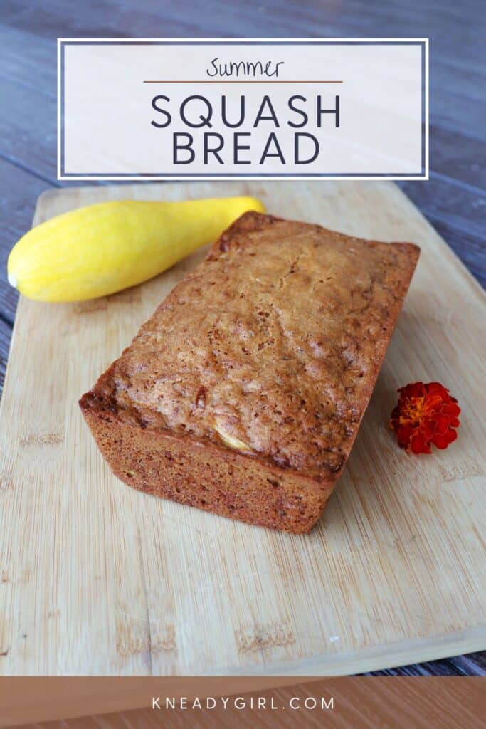 A loaf of quick bread on a cutting board with a marigold flower and yellow squash. Text overlay reads: Summer Squash Bread.