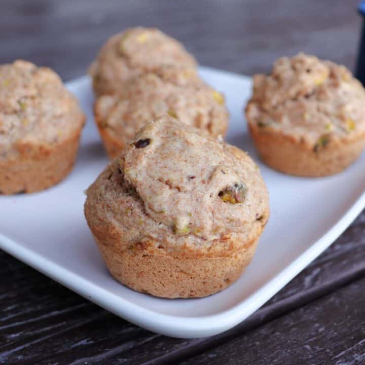Spelt muffins arranged on a square white plate.