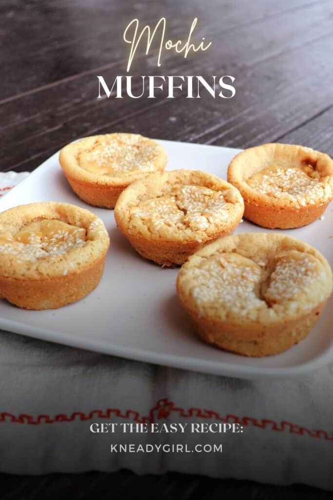 5 sesame topped muffins on a white plate. Text overlay reads: Mochi Muffins.