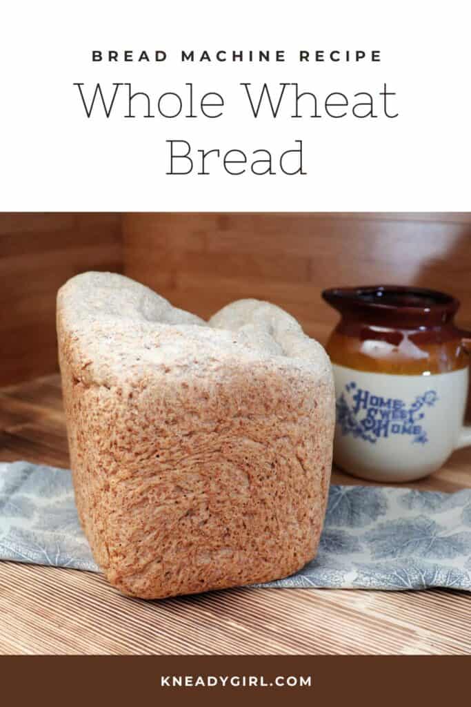 A loaf of bread sits on a piece of cloth with an earthenware pitcher in the background. Text overlay reads: Bread Machine Recipe - Whole Wheat Bread.