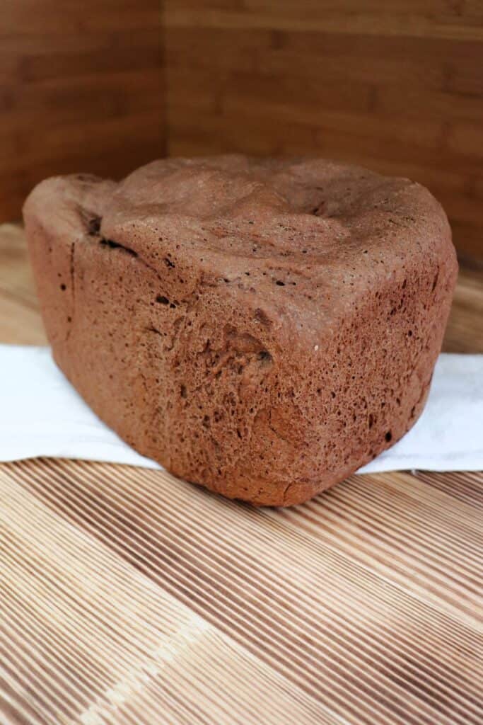 A loaf of Russian Rye Brread sits on a white cloth. 