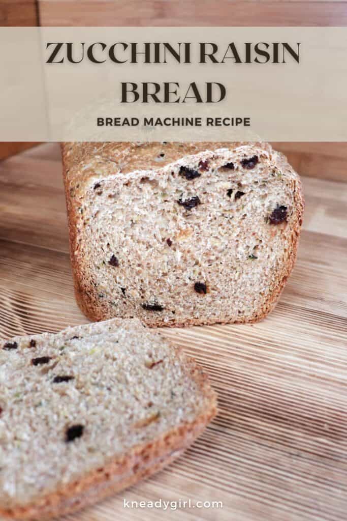 A loaf of bread with the end cut off exposing raisins inside sits on a board. Text overlay reads: Zucchini Raisin Bread - Bread Machine Recipe. 