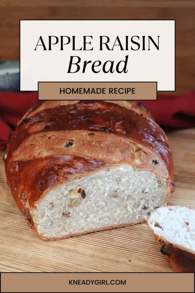A loaf of bread with the end cut of exposing the insides sits on a board. Text overlay reads: Apple Raisin Bread - Homemade Recipe. 