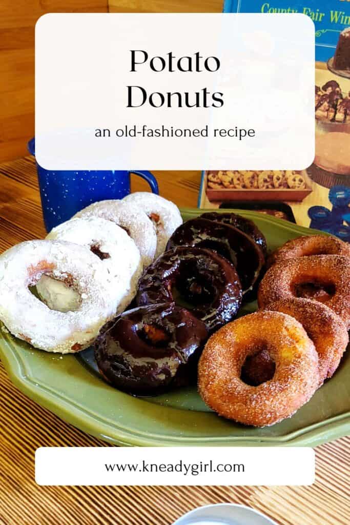 Donuts sit on serving platter, some are coated in powdered sugar, some in a chocolate glaze and some in cinnamon sugar. A text overlay box reads: Potato Donuts - an old-fashioned recipe. 